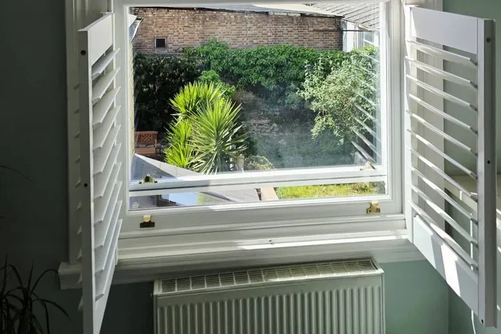 Bespoke timber window shutters fitted by Windows Store Ltd in a London home